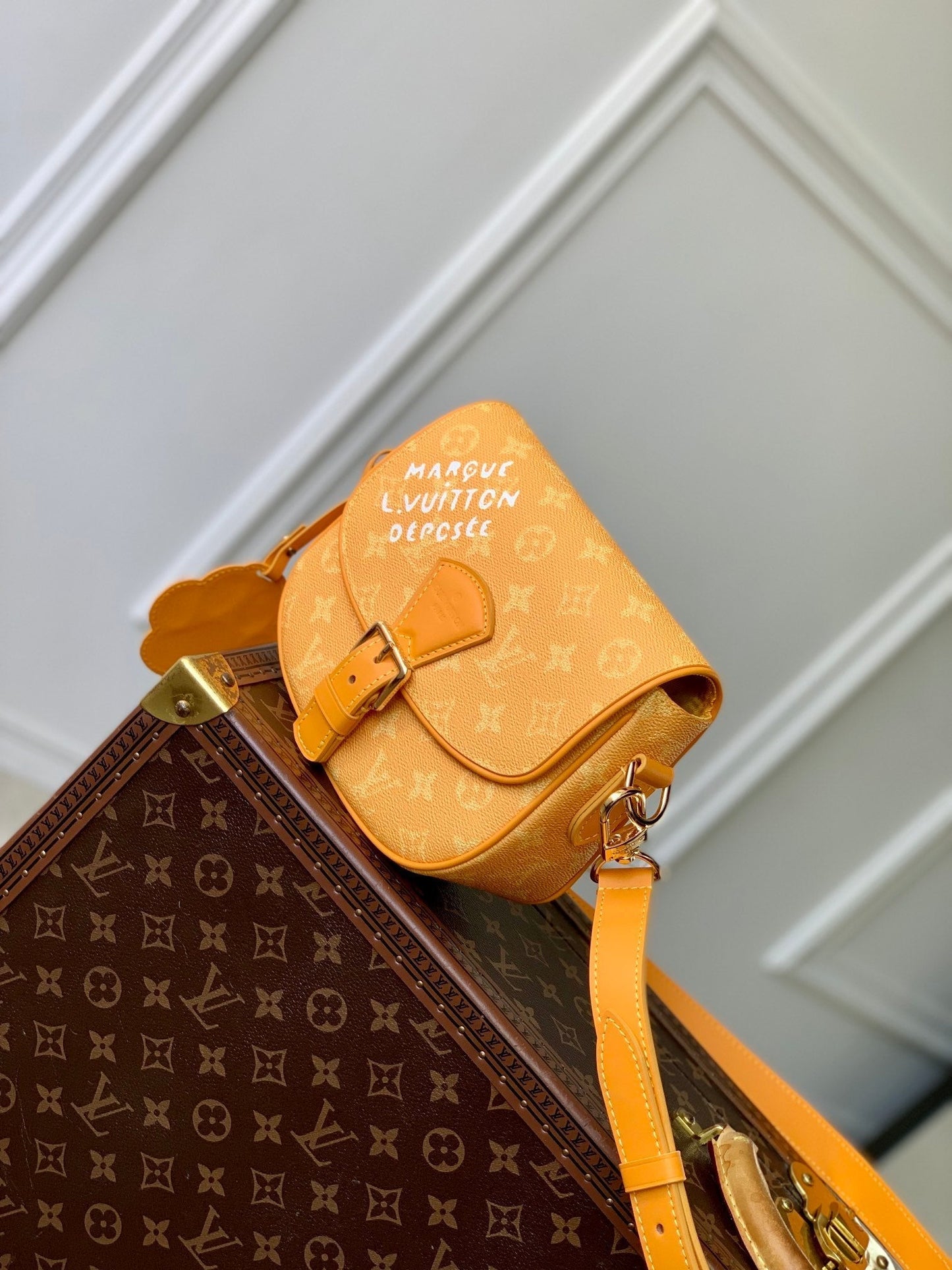 MONTSOURIS MESSENGER PM 20 IN PEPPER ORANGE MONOGRAM HERITAGE CANVAS